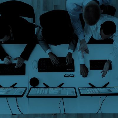 Laptop computer with opened lid on table in meeting room of office workspace.